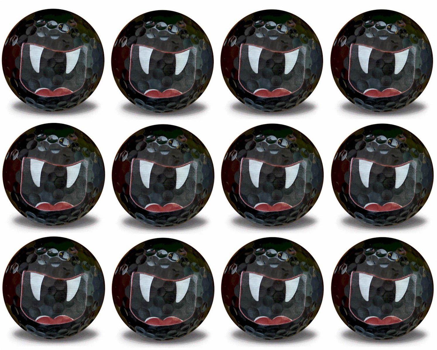 white vampire fangs and mouth on a black golf ball